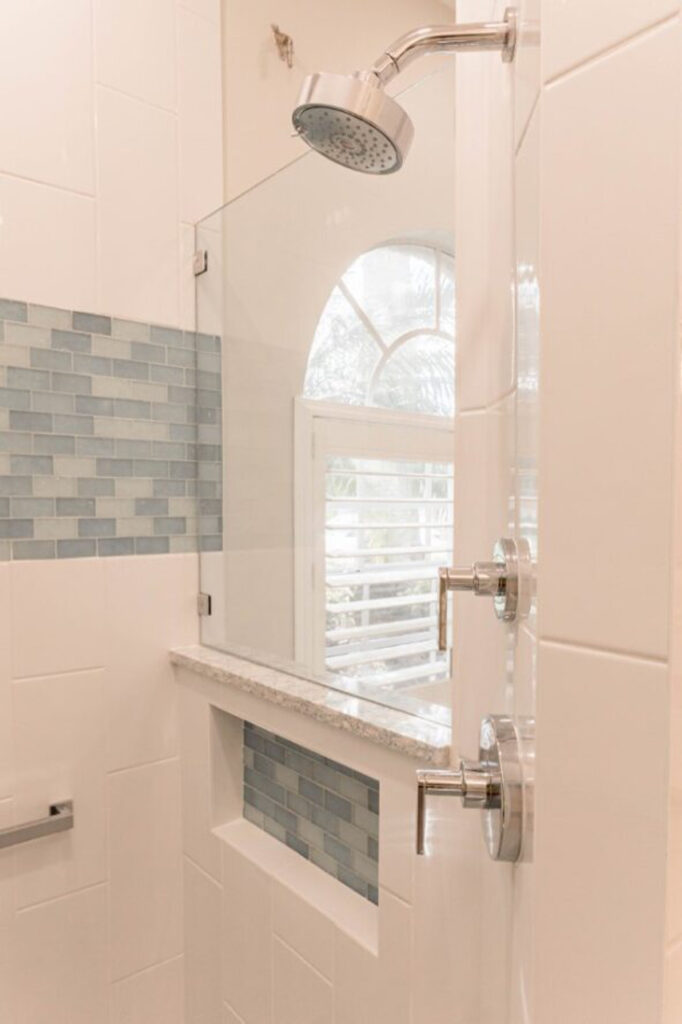 Large white custom home's remodeled bathroom stand-up shower
